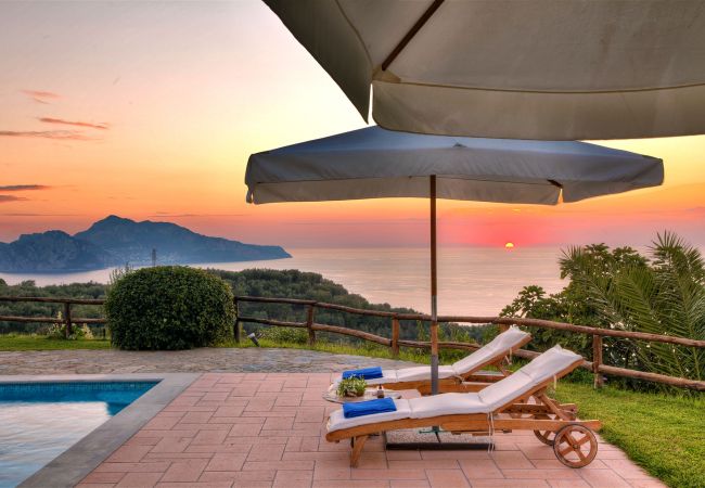 stunning view of capri island at sunset from pool terrace casale la torre, holiday apartments, massa lubrense, italy