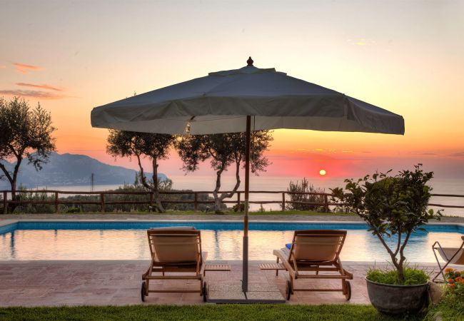 sunset on capri island from the pool, casale la torre, holiday apartments near sorrento, massa lubrense, italy