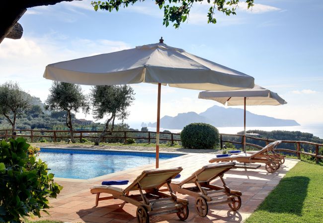 pool, sunbeds, sun umbrellas and capri island view, casale la torre, holiday apartments near sorrento, massa lubrense, italy