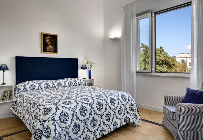 bright double bedroom with opened panoramic window, vacation villa la casa bianca, massa lubrense, italy