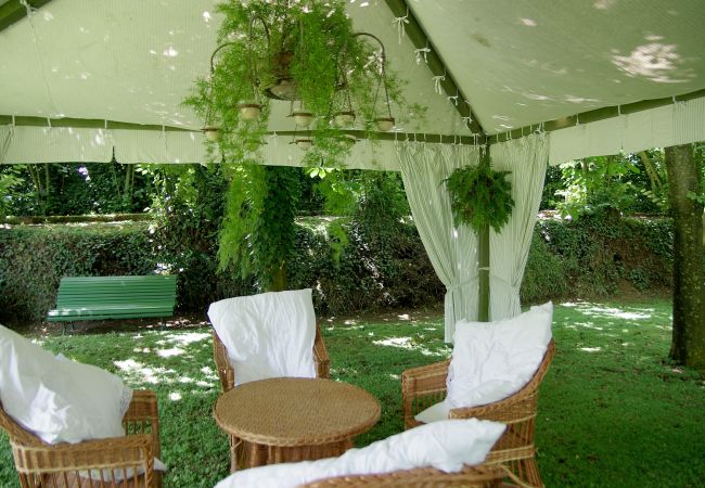 gazebo with table and chairs in the garden, villa mellicata, massa lubrense, italy