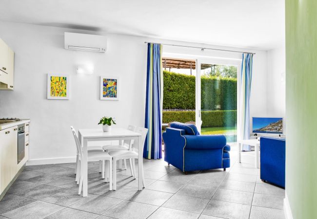 bright and modern living room, blue sofas, holiday apartment tosca, sant’agata sui due golfi, italy