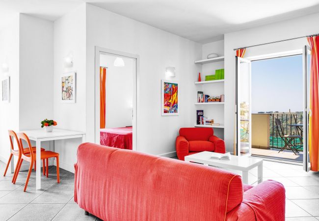 living area, in orange, with opened balcony, boheme holiday apartment