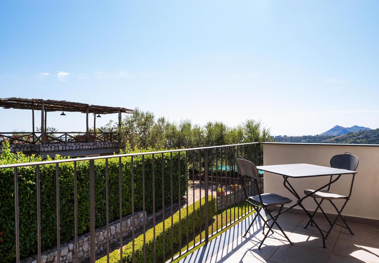 panoramic terrace corner with little iron table and chairs, boheme holiday apt