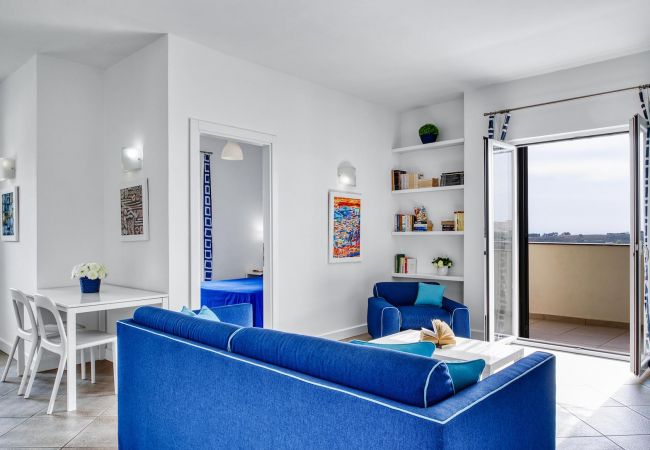 living area, in blu, with opened bright balcony, bedroom entrance, aida apt