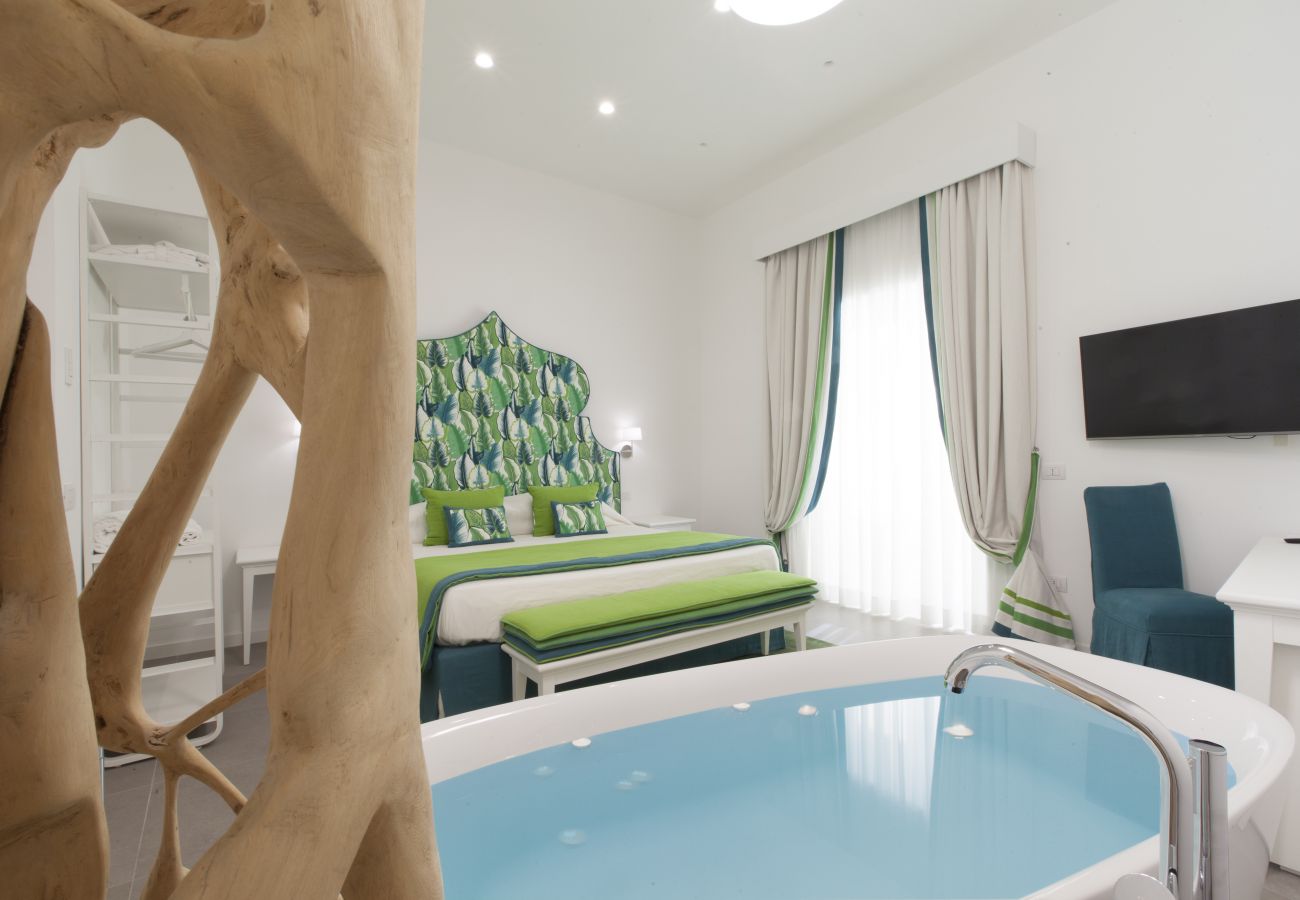 modern double bedroom with bath & tv, holiday apartment green suite, sorrento, italy