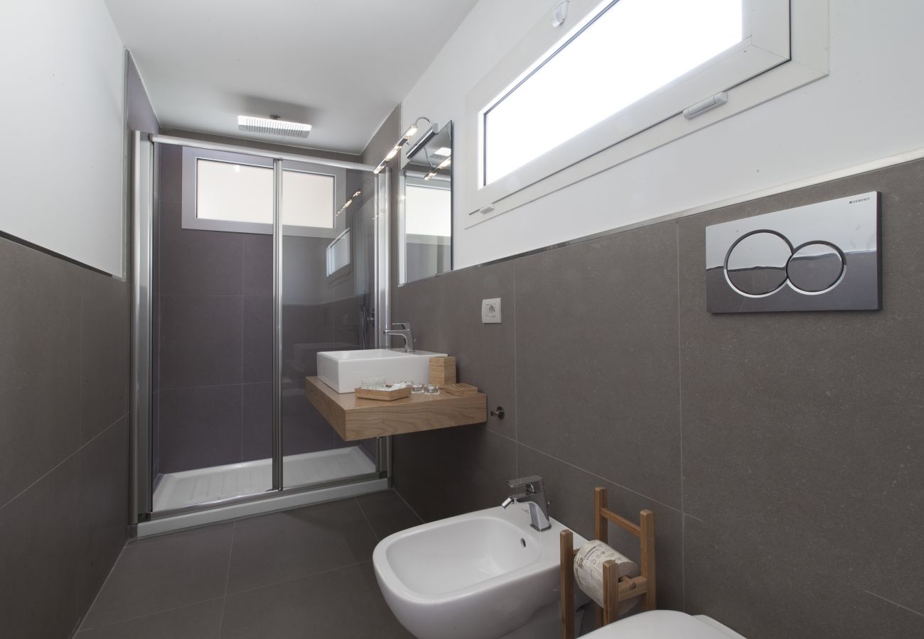 wide modern bathroom with two windows, holiday apartment green suite, sorrento, italy